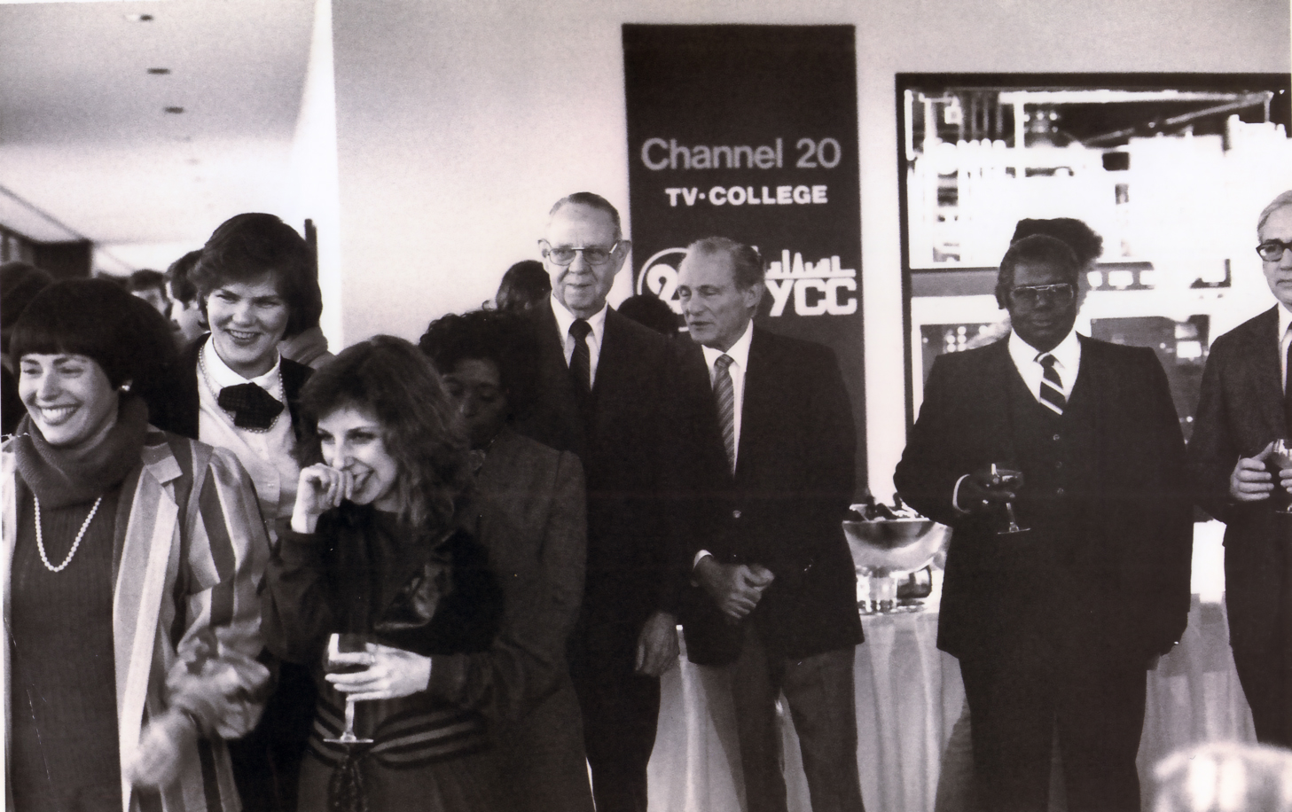 The Premiere Broadcast. L-R: (front row) Elynne Chaplik-Aleskow; Shelly Pazzol, director of Public Relations (second row)  Ginny McGann, director of station operations; unidentifield board member; (back row) unidentified board member, Chancellor Oscar Shabat, two unidentifield board members